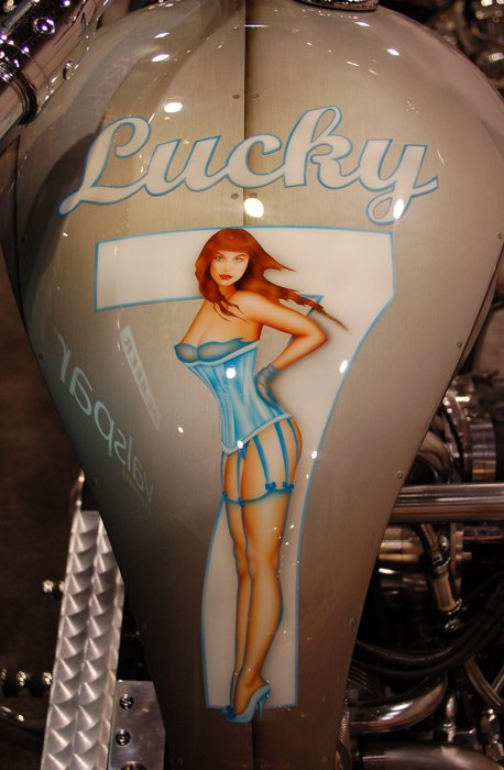 Pinup girl airbrushed on a painted raw metal effect basecoat.