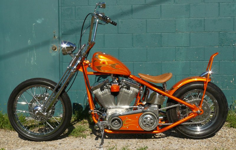 We painted this chopper for the Today Show. We did all of the paintwork from the metal up. Bodywork and molding on the frame, the basecoat is orange pearl candy. Our own special mix. The flames are gold leaf which are pinstriped.