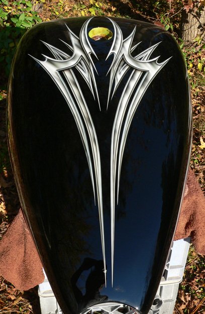 Black basecoat with metal effect airbrushed tribal graphics.