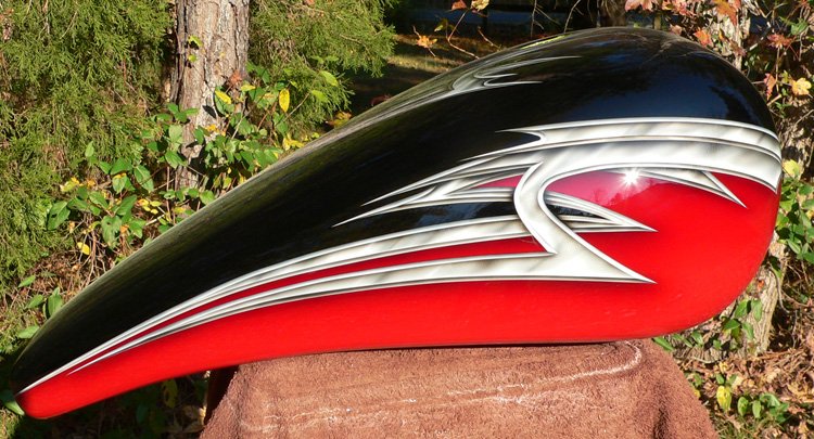 Black basecoat two toned with brillant red bordered by metal effect tribal airbrushed graphics.