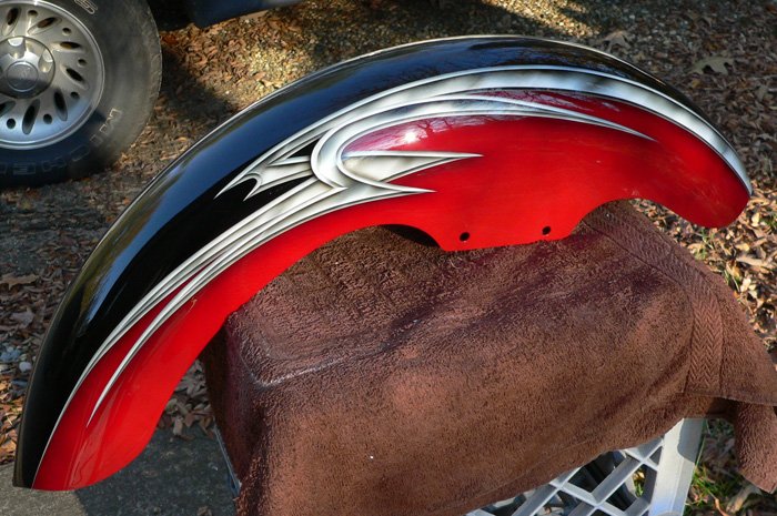 Front fender- black basecoat two toned with brillant red with metal effect airbrushed tribal graphics.